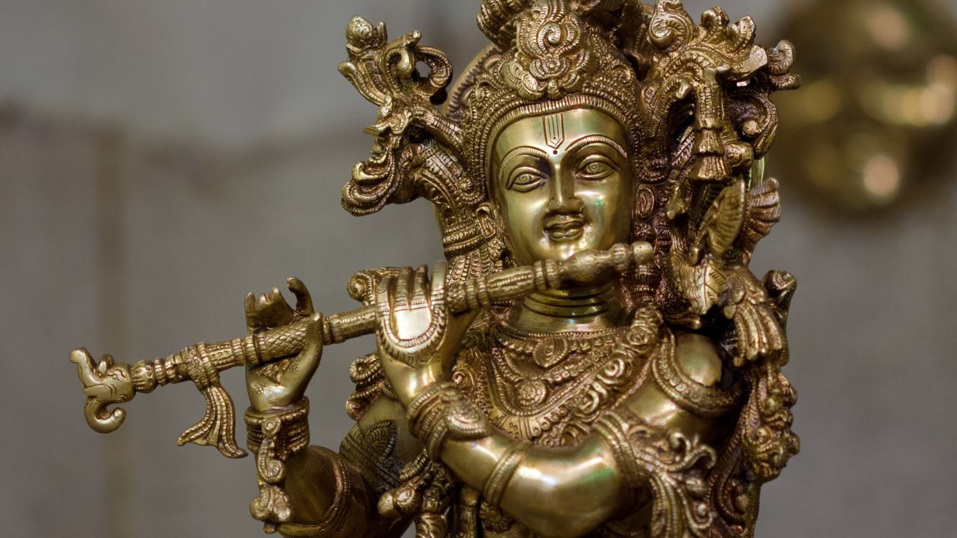 Brass statue of Indian design plays flute